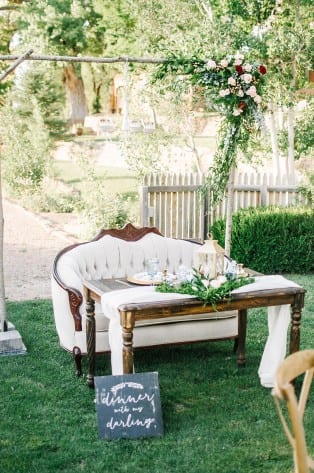 Lisa Anne Photography. Darling Details Vintage Decor. White sofa at an outdoor wedding