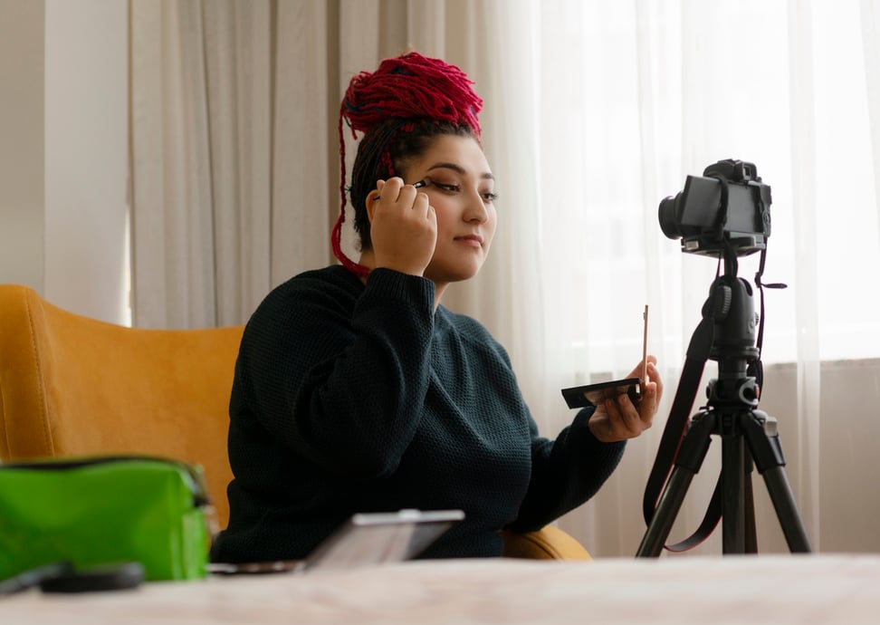Makeup influencer recording a YouTube video