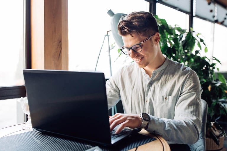 Homem jovem no computador programando em software house.
