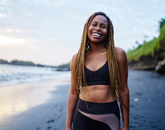 Fit woman on the beach with a figure you can attain with CoolSculpting