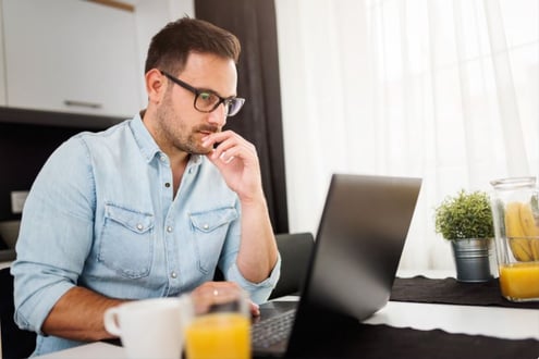 Man at desk processing software