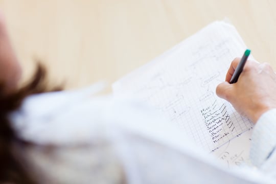 Teacher with attendance list ticking names of students