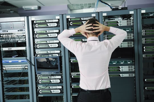 it business man in network server room have problems and looking for disaster situation solution-1