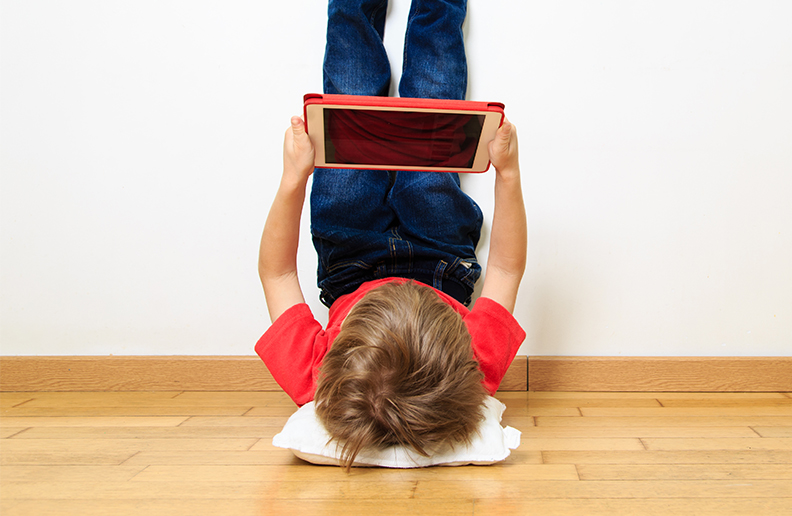 A child streaming video on a tablet.