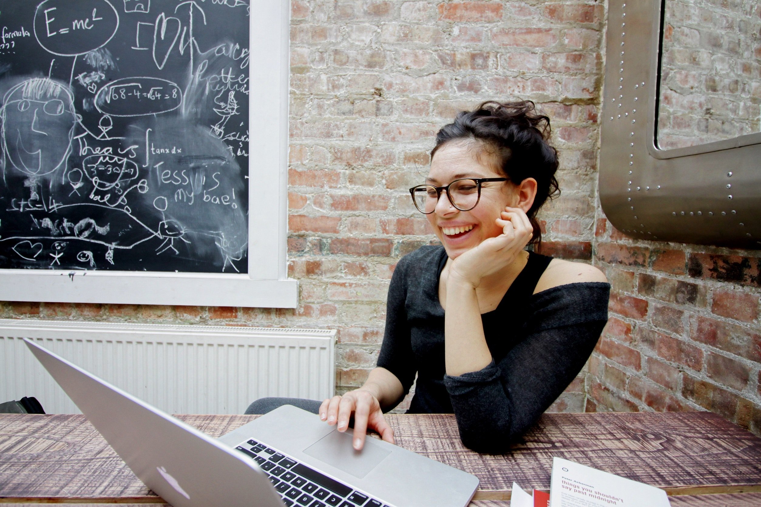 Woman smiling working on laptop