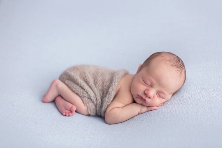 newborn baby photo lying on side