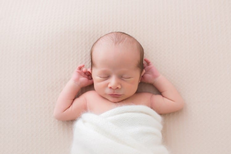 newborn baby photo in natural swaddling