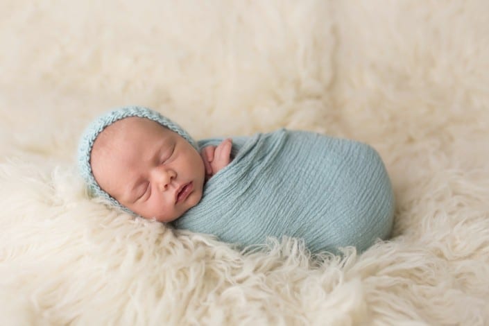 newborn baby photo swaddled on top of a blanket