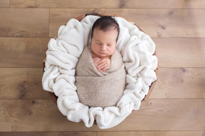 newborn baby photo fully swaddled in a prop