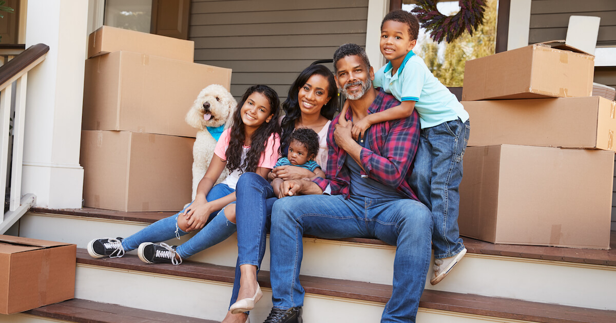 cute dog with family and moving boxes