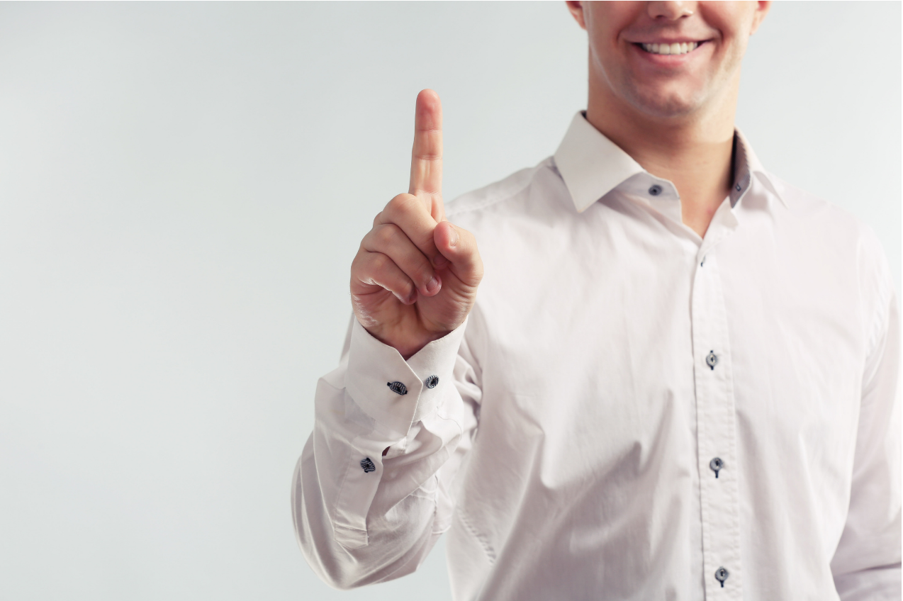 A man holiding up his finger to signal number one, to highlight one to one support