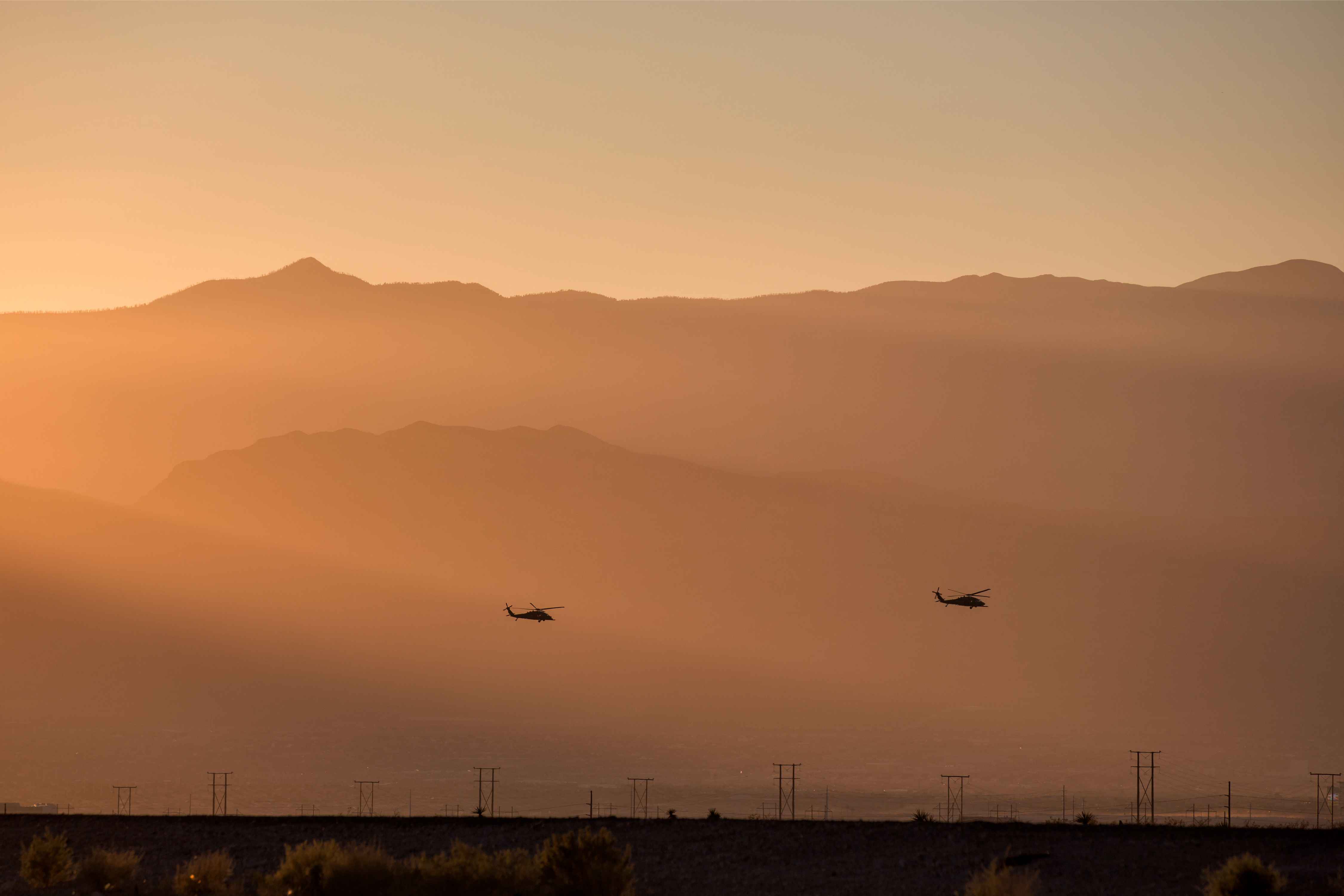 silhouette of helicopter with sunset demonstrating contract jobs middle east