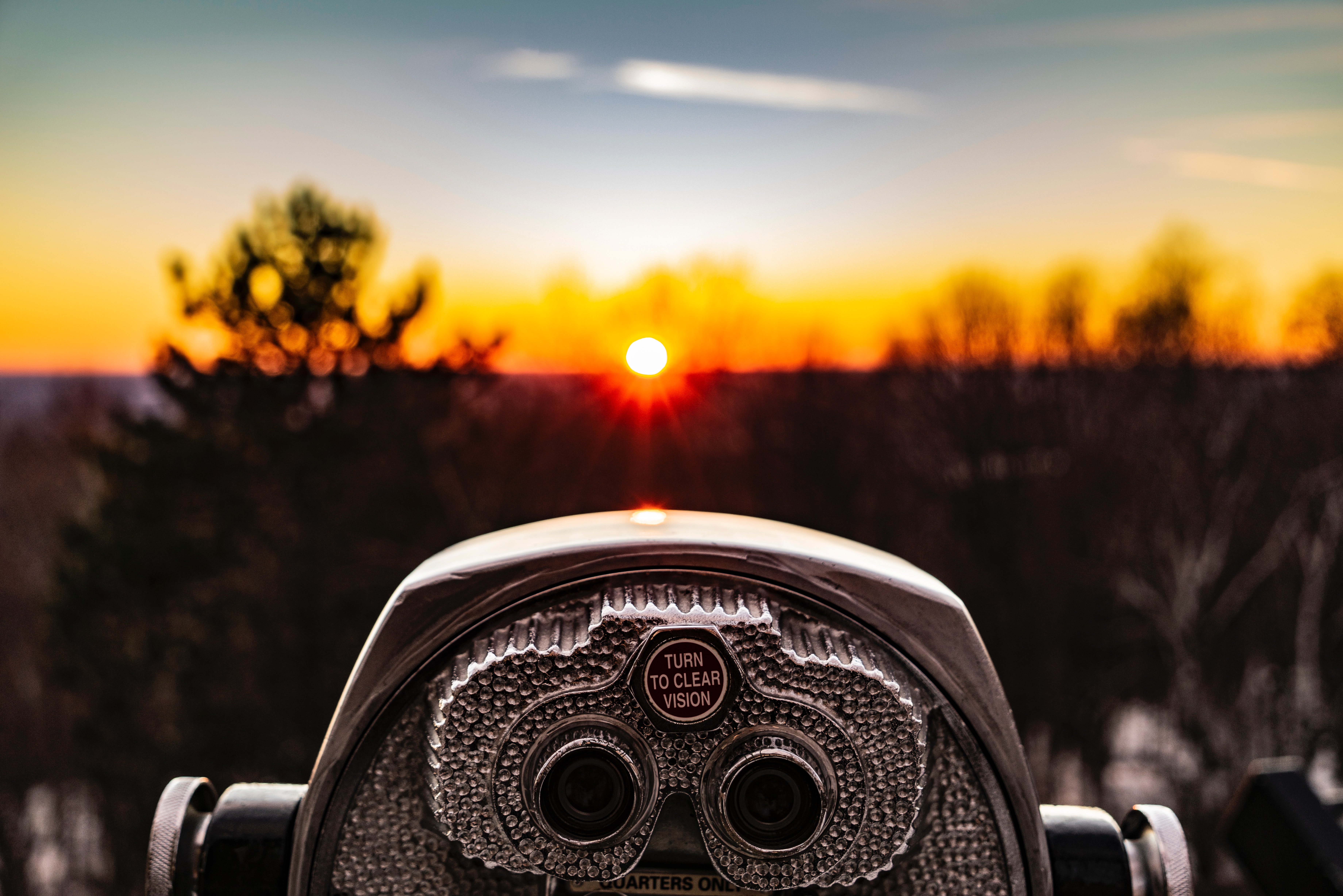Binoculars looking at a sunset 