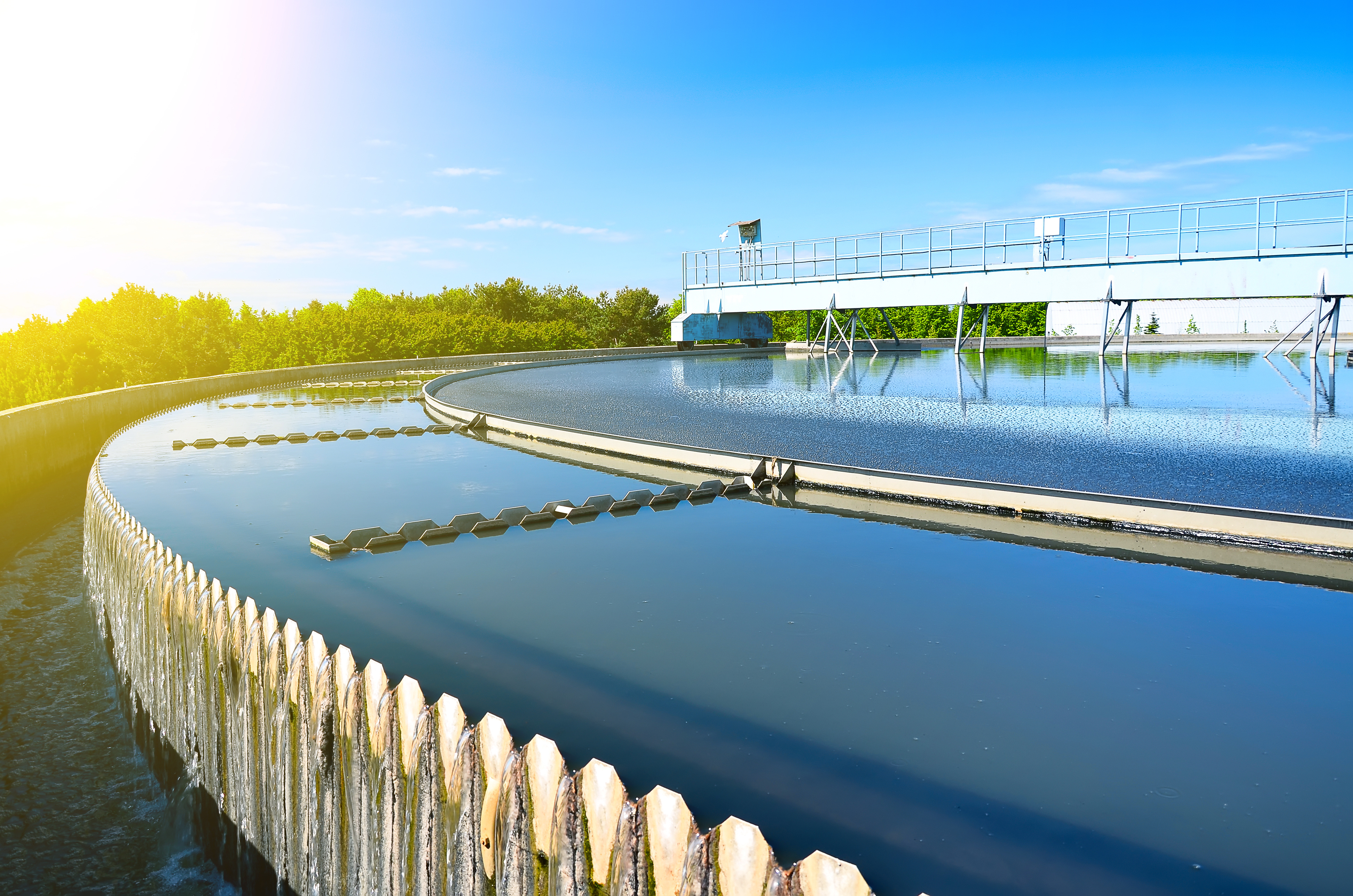 Adobe stock photo of sunrise over a wastewater facility