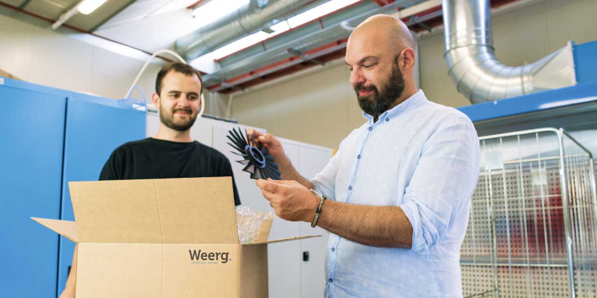 Two people receive a package from Weerg with their 3D printed parts