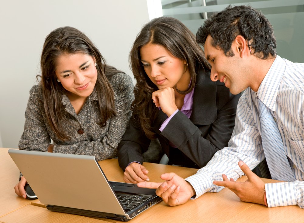 small business team in a meeting on a laptop computer in an office